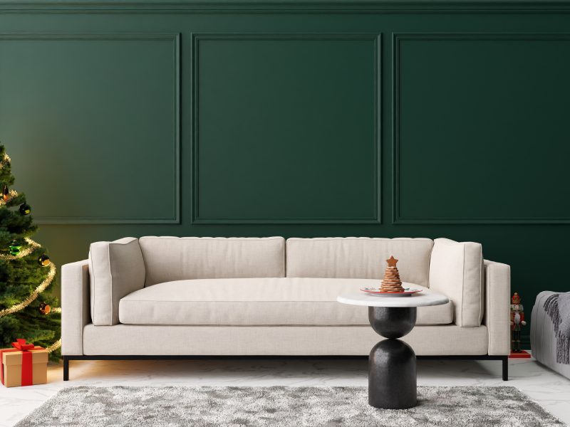 Empty green wall in modern living room with Christmas decoration. Mock up interior in classic style.